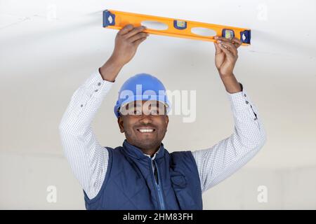 male engineer taking measures with spirit level Stock Photo