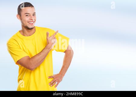 Young latin man latino showing pointing marketing ad advert people copyspace copy space male Stock Photo