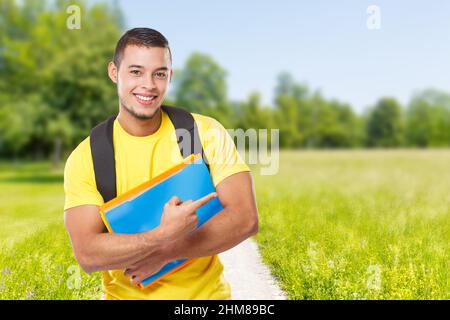 Student education pointing marketing copyspace copy space outdoor park ad advert young people outside Stock Photo
