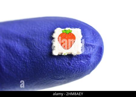 Strawberry trips-Blotting paper impregnated with the drug L.S.D.- Lysergic acid diethylamide. Stock Photo
