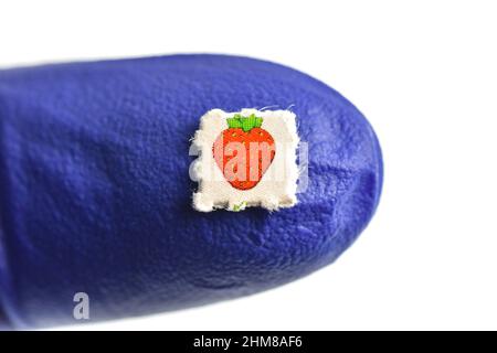 Strawberry trips-Blotting paper impregnated with the drug L.S.D.- Lysergic acid diethylamide. Stock Photo