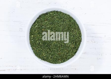 Dill herb from above bowl wooden board wood Stock Photo