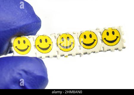 Smiley face acid trips, Blotting paper impregnated with the drug L.S.D.- Lysergic acid diethylamide. Stock Photo