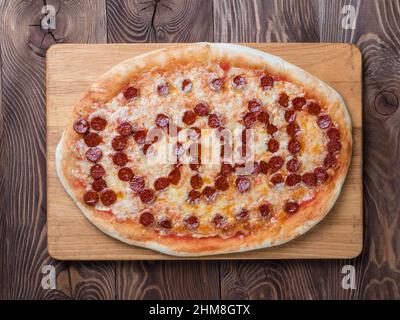 Father's day background. Pepperoni pizza with i love dad lettering on wooden tabletop. Father day concept, recipe and idea. Top view or flat-lay. Stock Photo