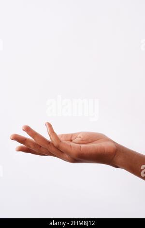 I have just what you need. Studio gesture of an unrecognizable womans hand against a white background. Stock Photo