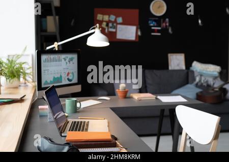 Image of workplace in front of the window with laptop for online work at home Stock Photo