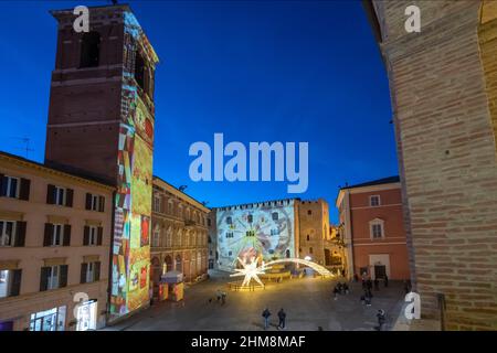 Piazza del Comune square, bright artistic Christmas decorations, Video Mapping on the Civic Tower and Palazzo del Podestà, Fabriano, Marche, Italy, Eu Stock Photo
