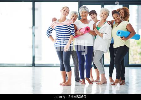 Keeping fit as they age. Shot of a group of women waiting for yoga class to begin. Stock Photo