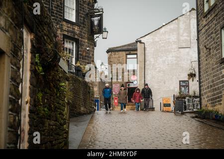 Haworth, UK: Main Street in Howarth, West Yorkshire attracts tourists from around the world because of its connections to the Bronte Sisters. Stock Photo