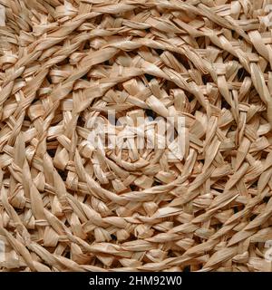 Circular pattern of woven seagrass basket. Abstract background - natural rattan or sea grass in circular woven. Minimalistic simple beige rustic and natural pattern background Stock Photo