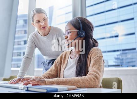 I hope you enjoy working with us. Shot of a young businesswoman in her office with her senior manager. Stock Photo