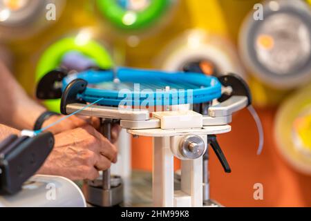 manual stringing of a tennis racket in service Stock Photo