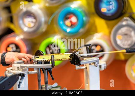 manual stringing of a badminton racket in service Stock Photo