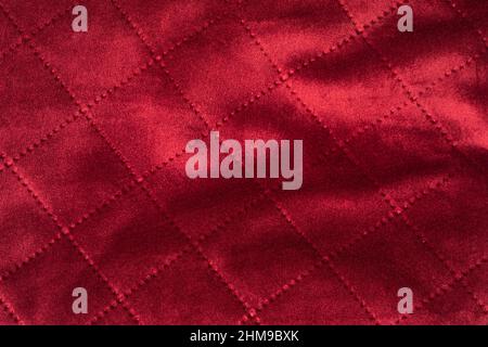 Full frame macro shot of red silky stitched couh fabric Stock Photo