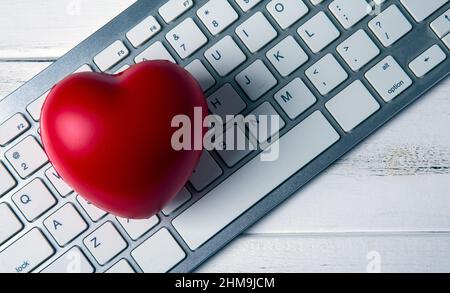 red heart on pc keyboard of notebook website Stock Photo