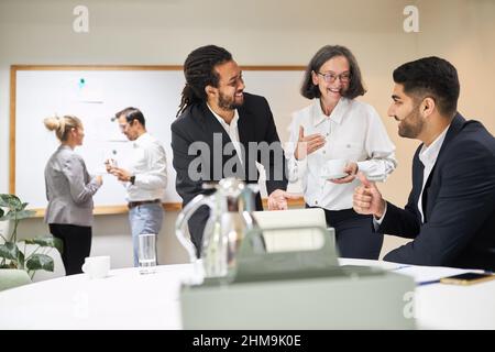 Successful multicultural business team people and boss discussing project in a workshop Stock Photo