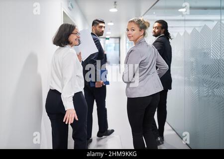Group of business people in a hurry on their way to a negotiation or appointment in the office corridor Stock Photo