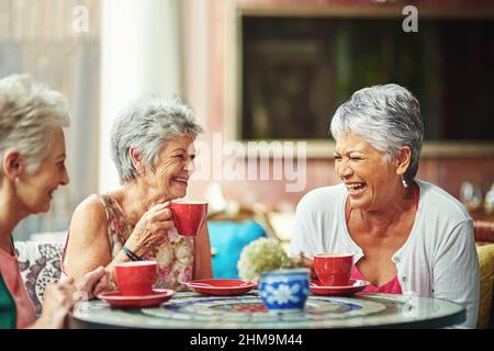 Lifelong friends catching up over coffee. Cropped shot of a group of senior female friends enjoying a lunch date. Stock Photo