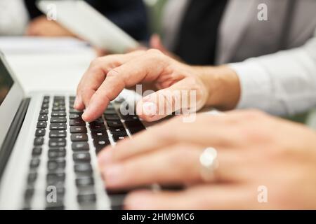 Hands of business man programming or typing on computer keyboard in office Stock Photo