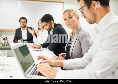 Business people working together with laptop computer in meeting or computing workshop in office Stock Photo