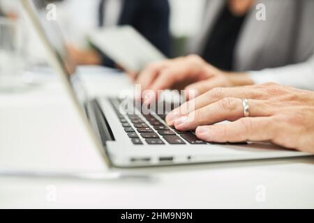 Hands of business man typing on computer keyboard while programming or e-learning Stock Photo