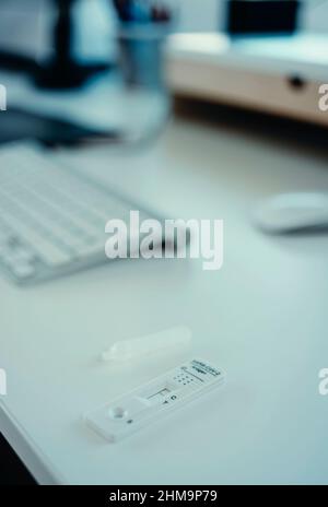 a covid-19 antigen diagnostic test device with a negative result on the white desk of an office Stock Photo
