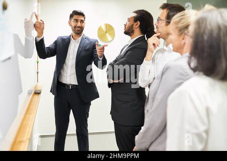 Young business man as a consultant and trainer in a coaching workshop giving a presentation Stock Photo
