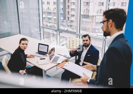 Focused colleagues working in modern workspace in daytime Stock Photo