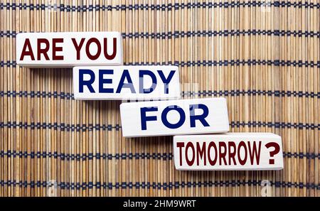 Wooden blocks with text ARE YOU READY FOR TOMORROW on brown straw background Stock Photo
