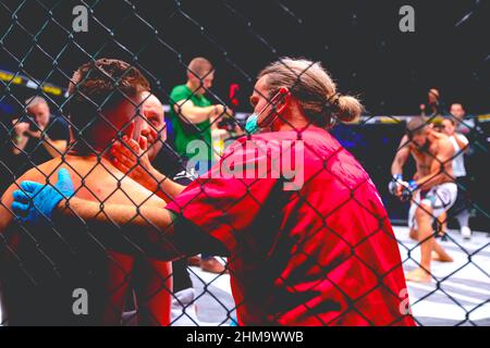 Zrenjanin, Vojvodina, Serbia October 16, 2021: MMA XXXVI SBC Tournament.  Group of medical personnel provides medical aid to the MMA fighter in fighti Stock Photo