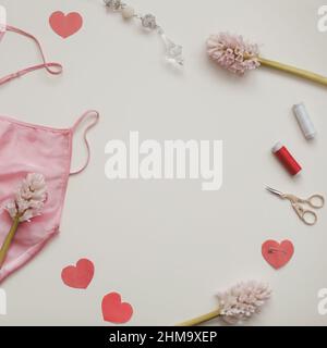 Flat lay with flowers, threads, textile, scissors and sewing accessories on white background. Sewing wokrshop, top view copy space Stock Photo