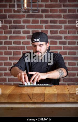 Back view of unrecognizable mindful young fit female athlete in sportswear stretching arms during workout in sunny city Stock Photo