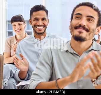 That was a stellar presentation. Shot of a group of businesspeople clapping hands during a presentation. Stock Photo