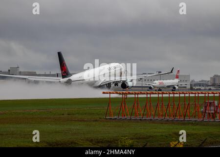 Montreal, Quebec, Canada 10-02-2021: Air Canada Airbus A330-300 taking off from Montreal on a rainy afternoon.  Registration C-GEFA, FIN 939. Stock Photo