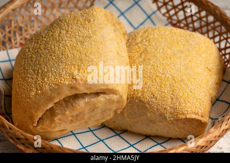 Pair of fresh baked corn buns in a basket close up Stock Photo