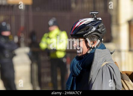 Robert Peston - Political Editor of ITV News - wearing a cycling helmet with a camera, outside Parliament, Jan 2022 Stock Photo