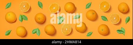 Fruit pattern arranged of oranges and orange leaves on orange background. Lay out background. Stock Photo