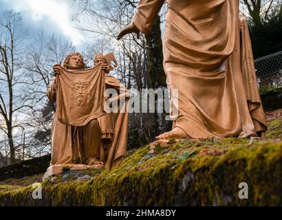 Lourdes, France - January 5, 2022: Way of the cross of Lourdes - sixth station: Veronika wipes the face of Jesus