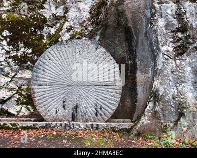 Lourdes, France - January 5, 2022: Way of the cross of Lourdes - fifteenth station: Jesus rises from the dead. A round stone closes the grave Stock Photo
