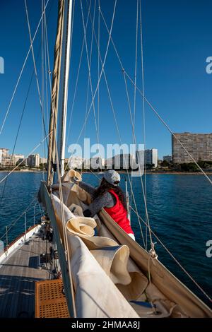 Adult Woman Pulling Rope on Sailboat , Alicante, Costa Blanca, Spain Stock Photo