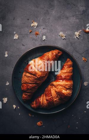 Plate of croissants on black surface Stock Photo