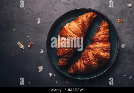 Plate with croissants on a black surface Stock Photo