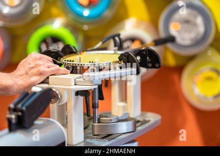 manual stringing of a badminton racket in service Stock Photo