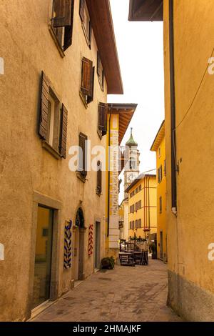 A street at Christmas in Pieve Di Ledro near Riva del Garda, Trentino-Alto Adige, Italy. Chiesa dell'Annunciazione di Maria church is in background Stock Photo