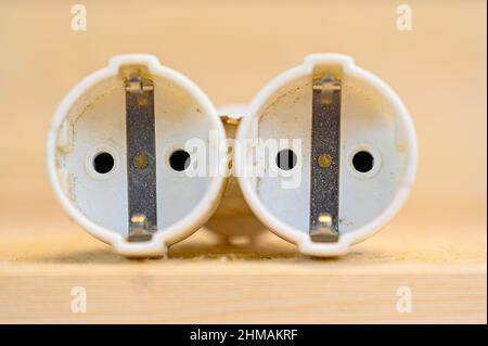 white plastic branch outlet on wooden bench Stock Photo