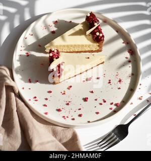 Sliced Cheesecake. Layer of biscuits, mousse based on creamcheese, with raspberry. Healthy dessert. Stock Photo
