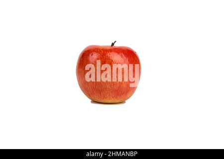 One artificial waxy red apple. Isolated over white background. Close-up. Stock Photo