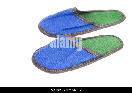 Slippers made of felt have a blue-green color. Isolated over white background. Close-up. Stock Photo