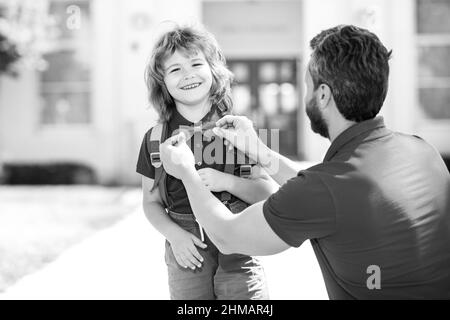 Funny nerd. Father supports and motivates son. Kid going to primary school. Kids education. Smart wunderkind in school uniform ready to school. Stock Photo