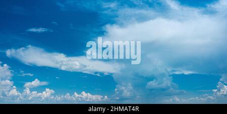 Deep blue sky and different types of white clouds in it. Beautiful nature background. Stock Photo
